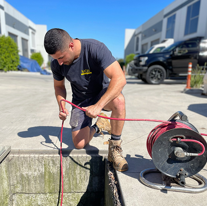 Clearing blocked drain by MCN Plumbing plumber