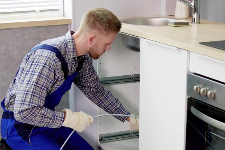 Plumber Clearing Drain Professionally